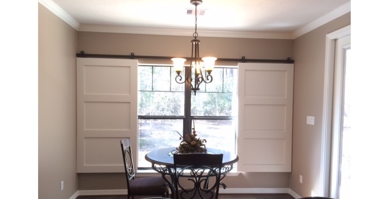 Barn doors open horizontally with slides instead of cords. San Antonio barn door shutters