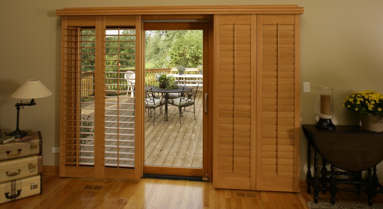 Wood shutters create a buffer that transitions from indoor wood to patio. San Antonio wood shutter sliding door